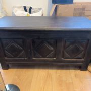Antique dark wood chest with geometric paneling / pointed