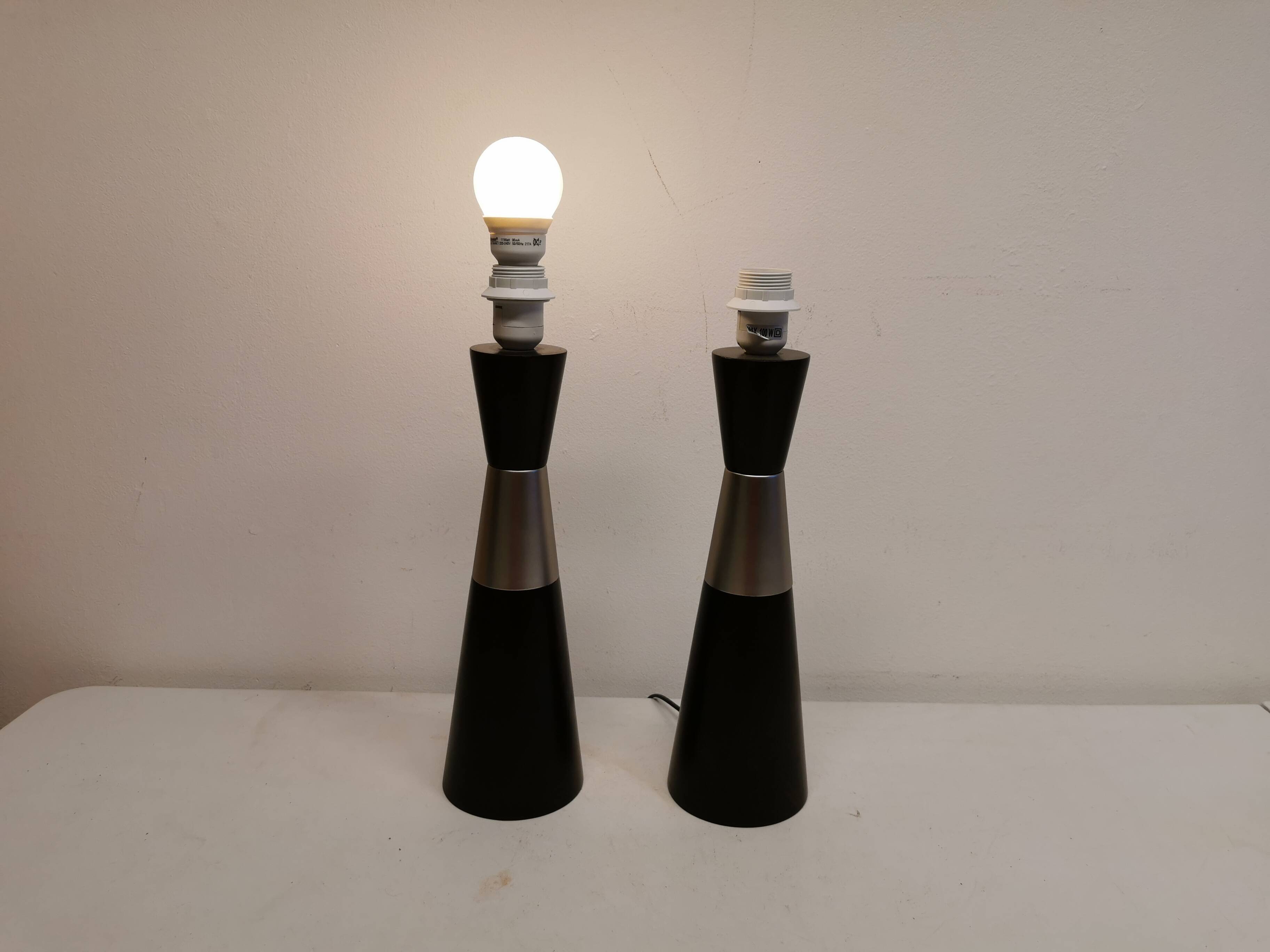 Two table lamps made of dark-stained wood with silver detail in the middle.