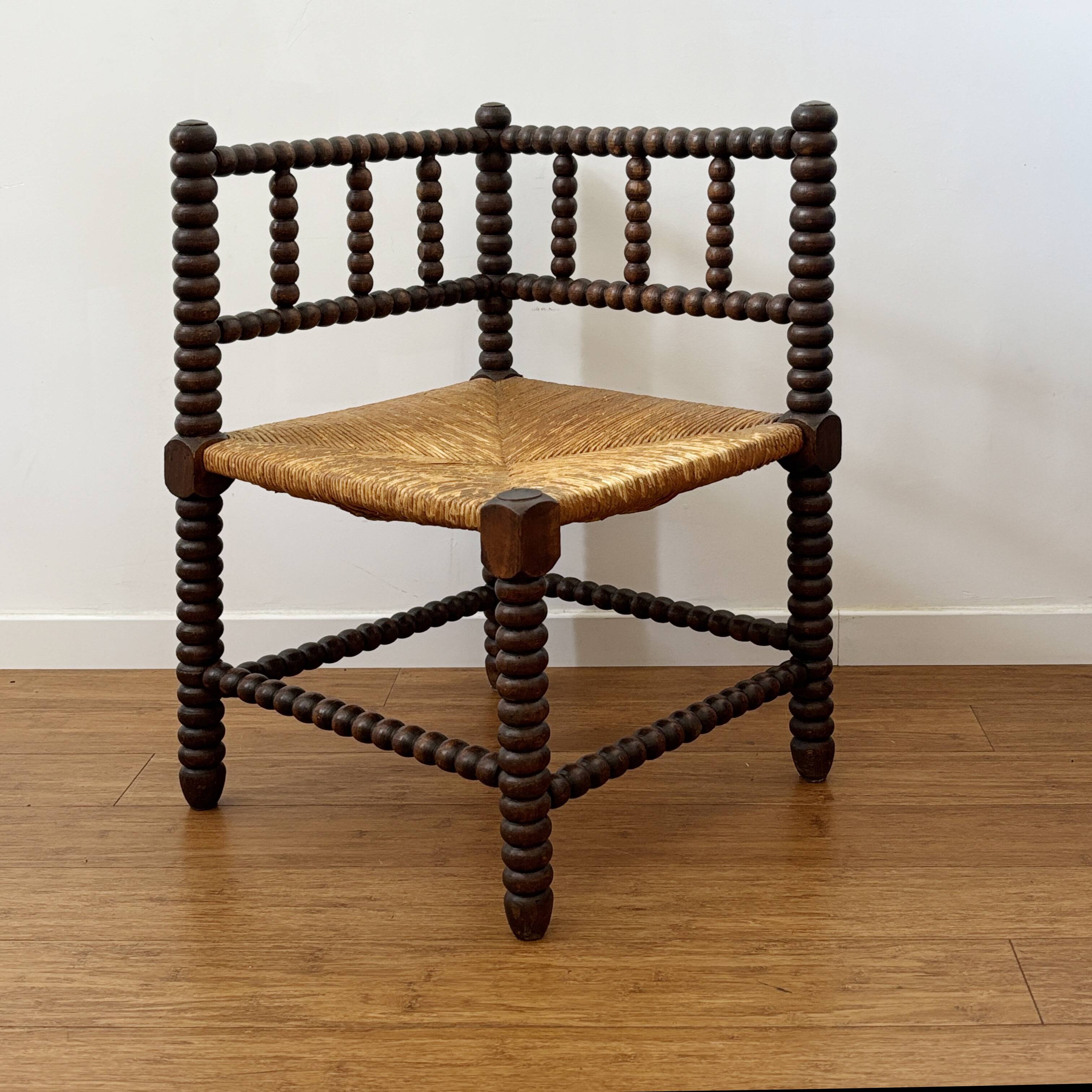 Turned wood corner chair with straw seat
