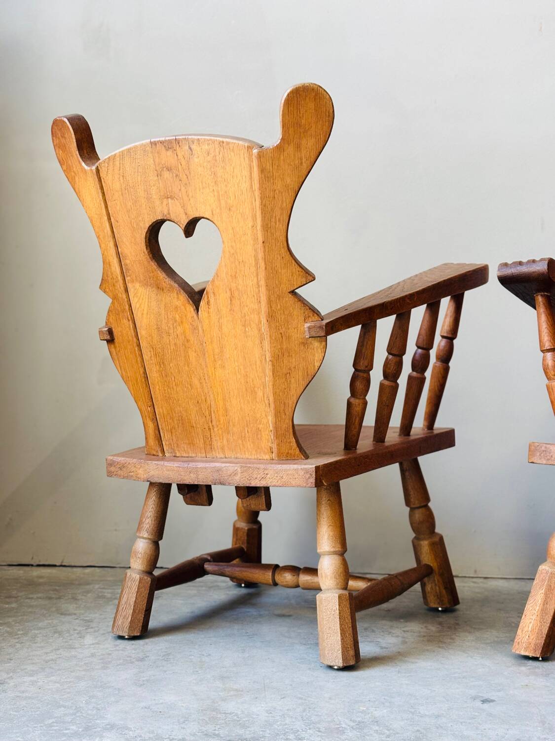 Pair of rustic oak armchairs – carved heart backrests