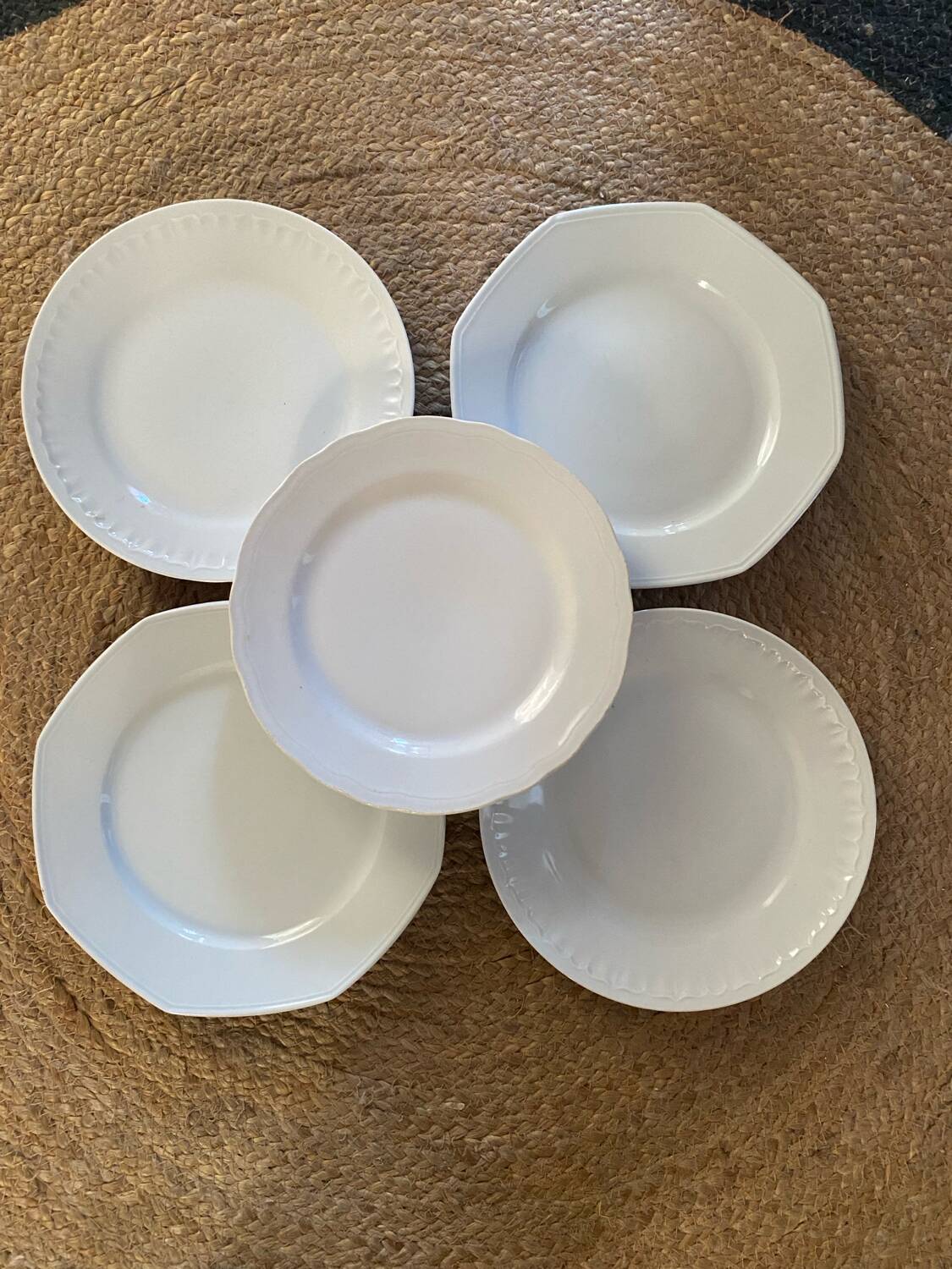 5 mismatched old white plates.