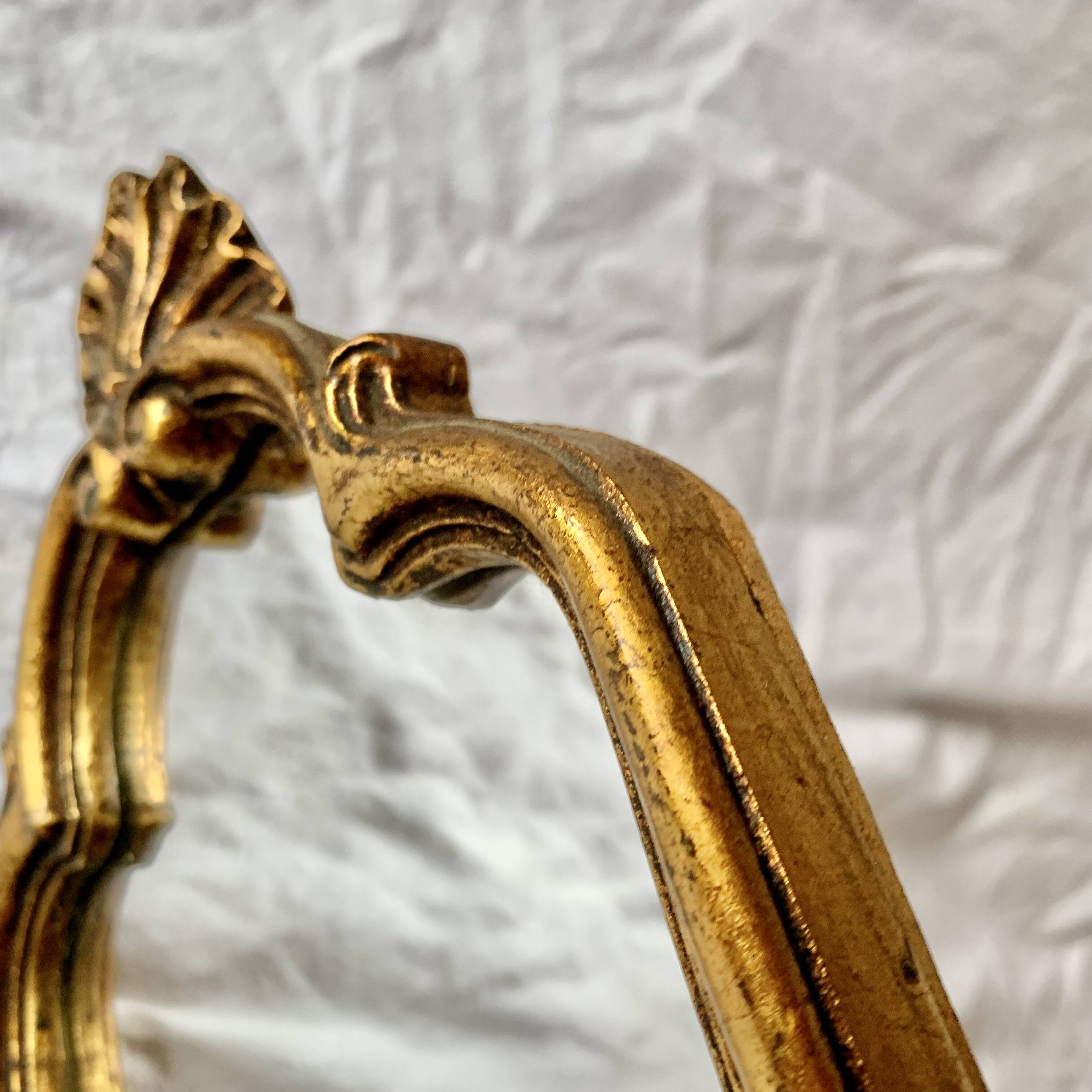 Old small wall mirror in golden resin