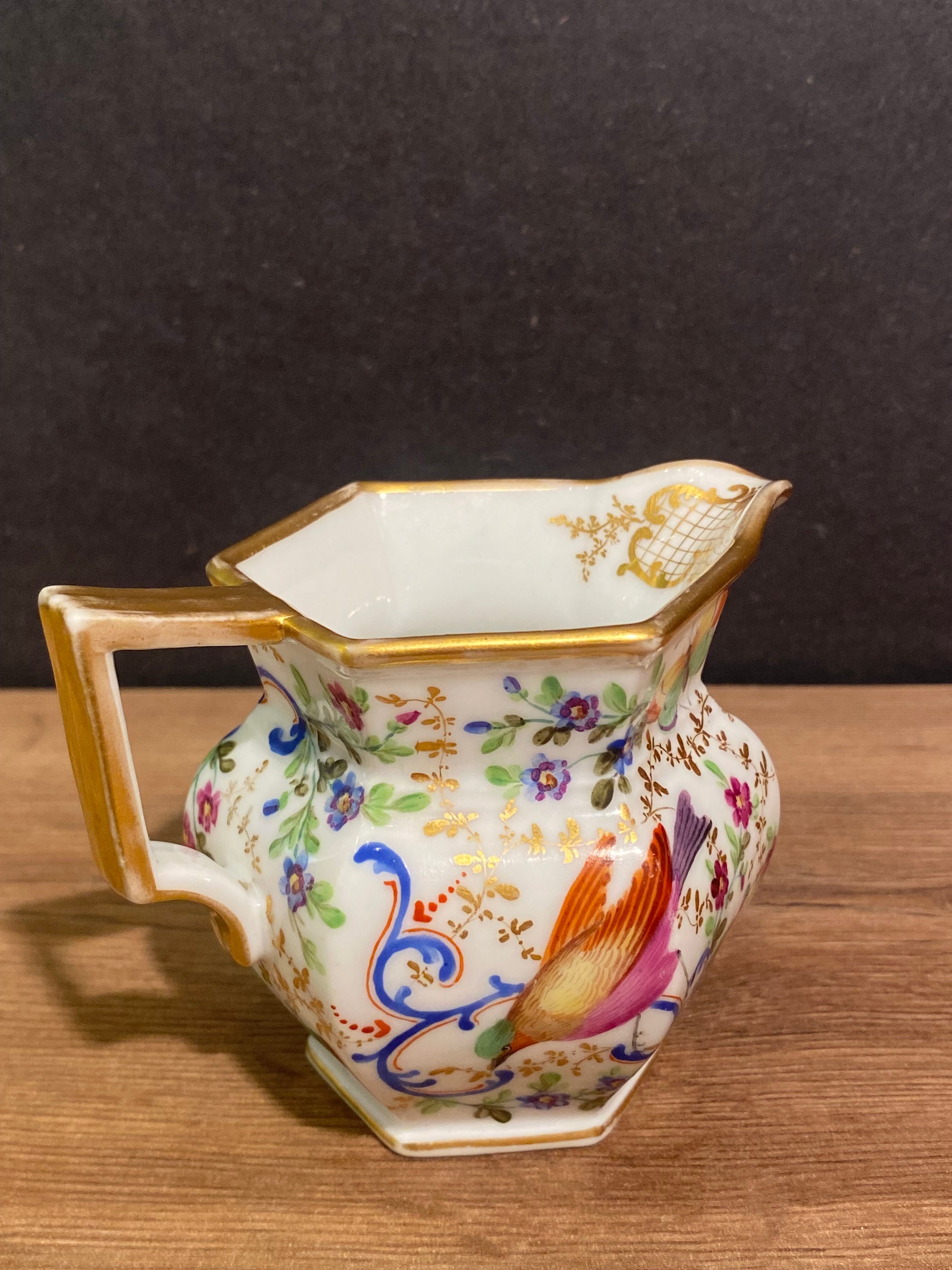 Old Paris porcelain milk jug with polychrome and gold bird floral decoration