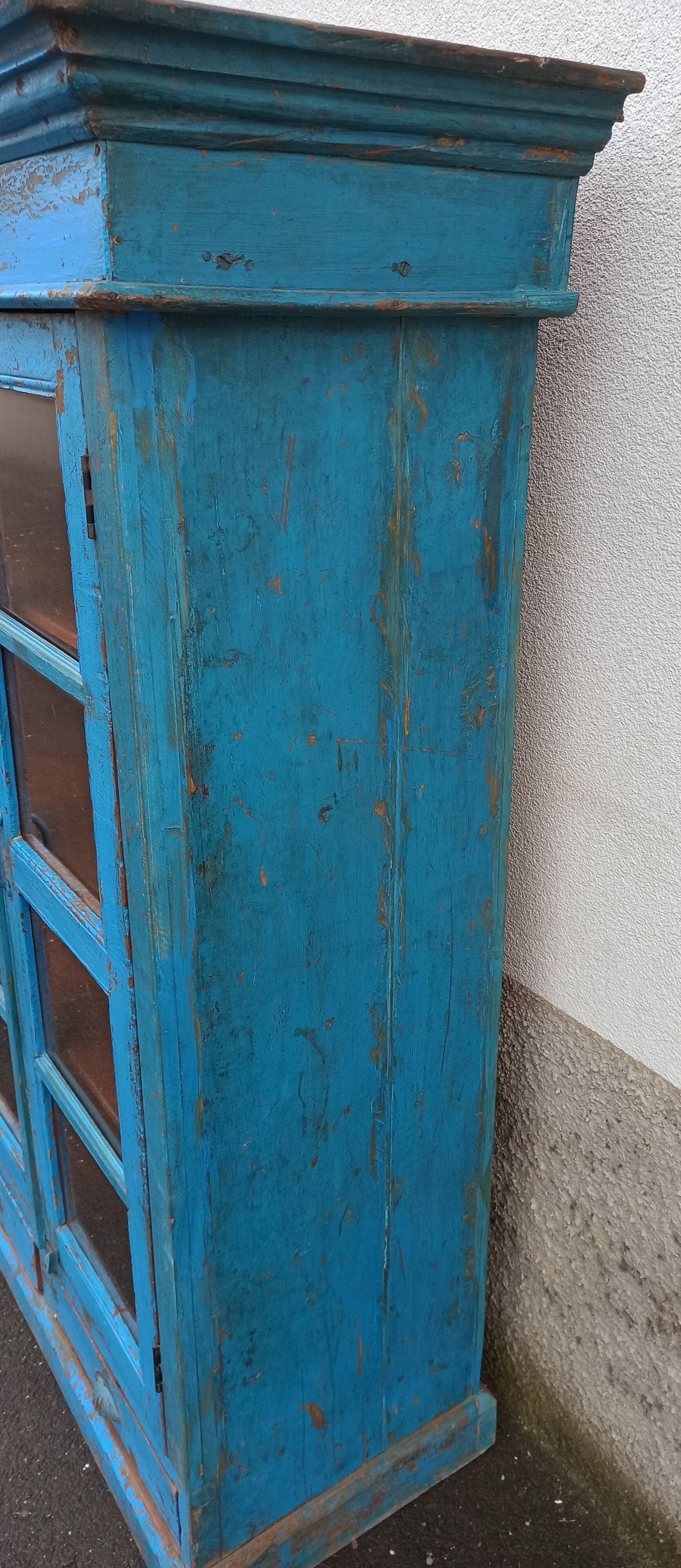 Old wooden glazed cabinet with two doors and two drawers