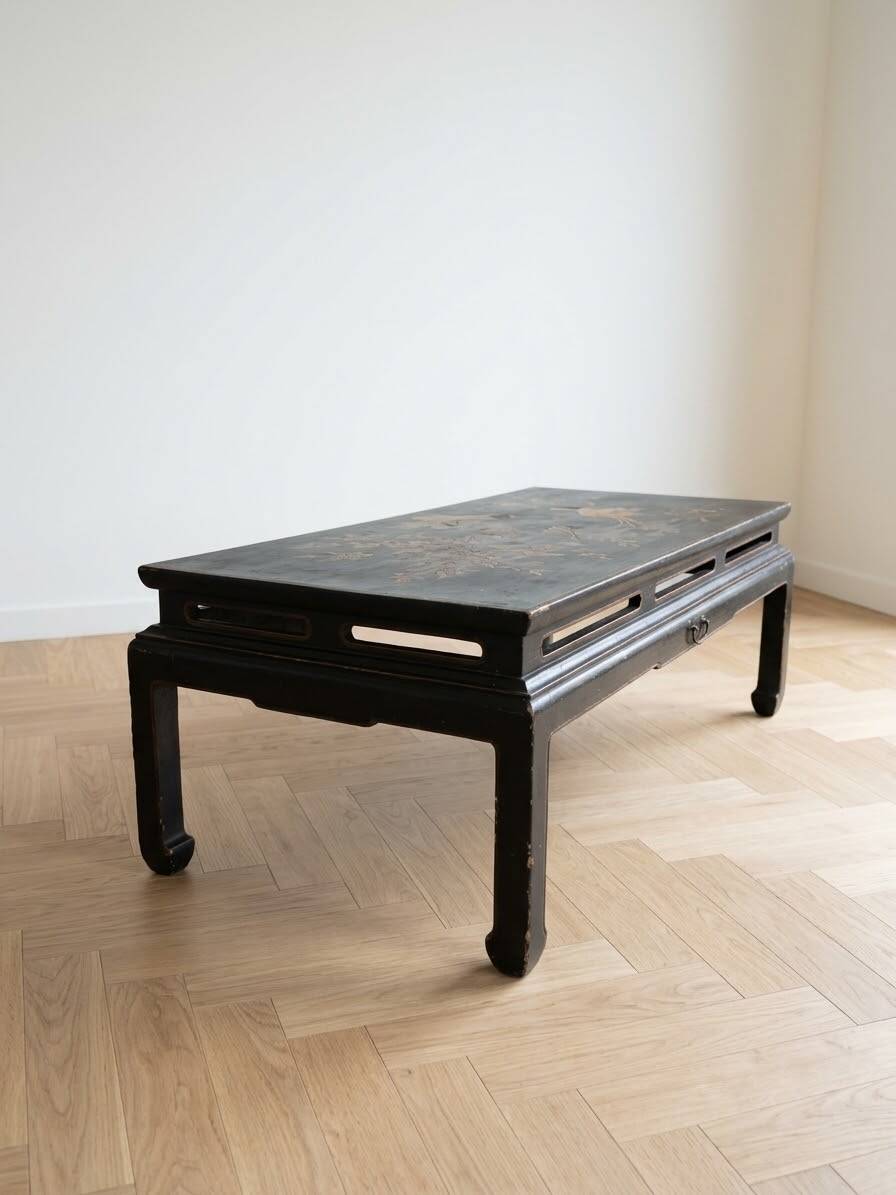 Antique Chinese coffee table in black and gold painted wood.