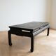 Antique Chinese coffee table in black and gold painted wood.