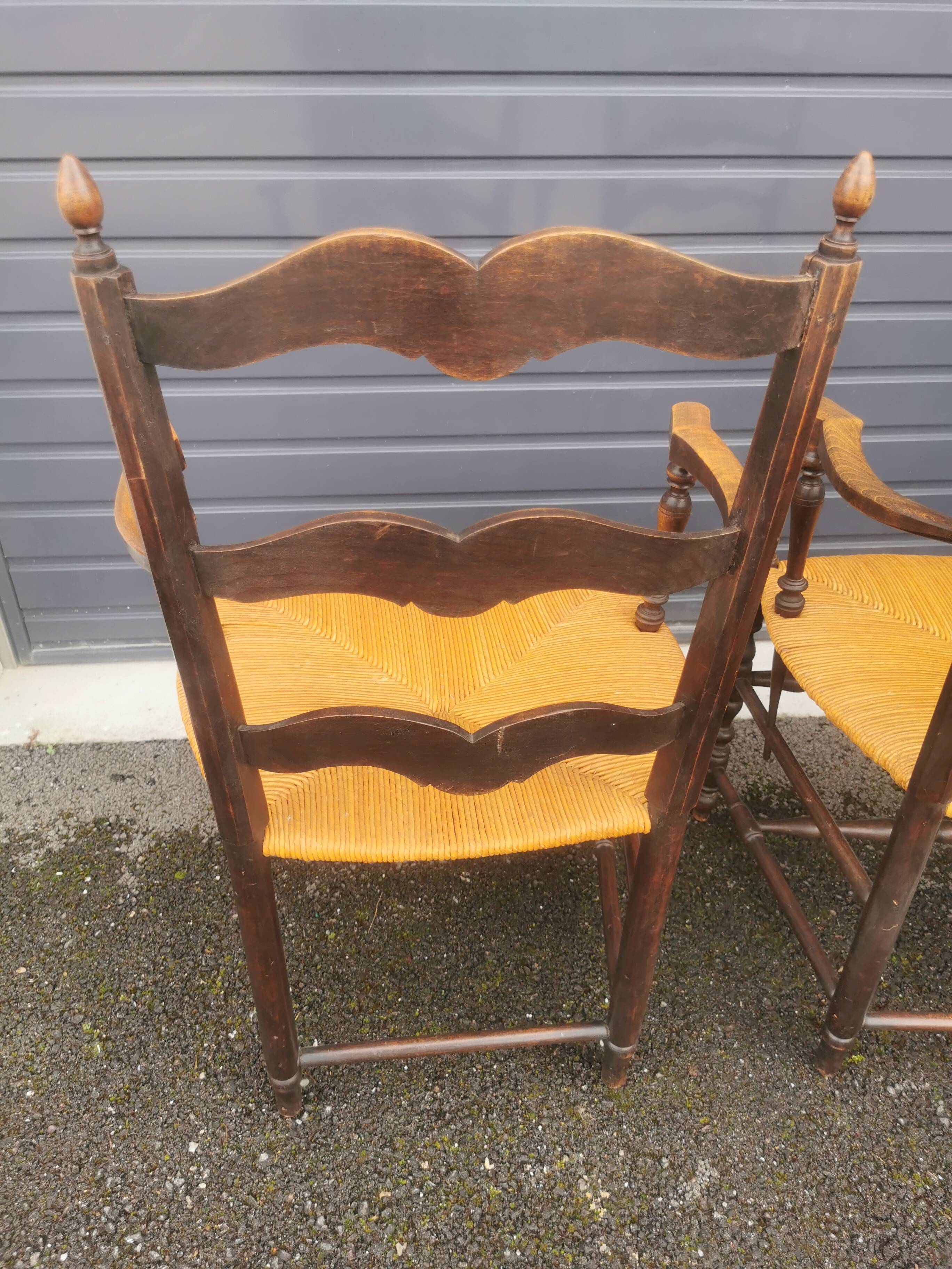 Pair of blackened wooden armchairs
