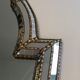 Mirror consisting of multi-faceted mirrors and brass garlands, French work, around 1970