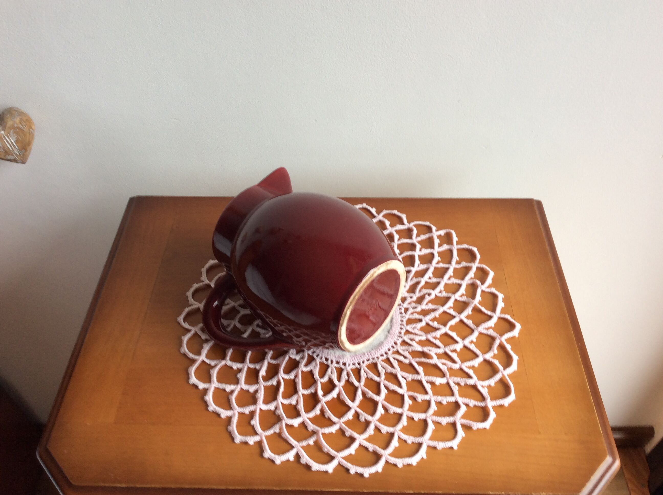 Old dark red ceramic pitcher jug