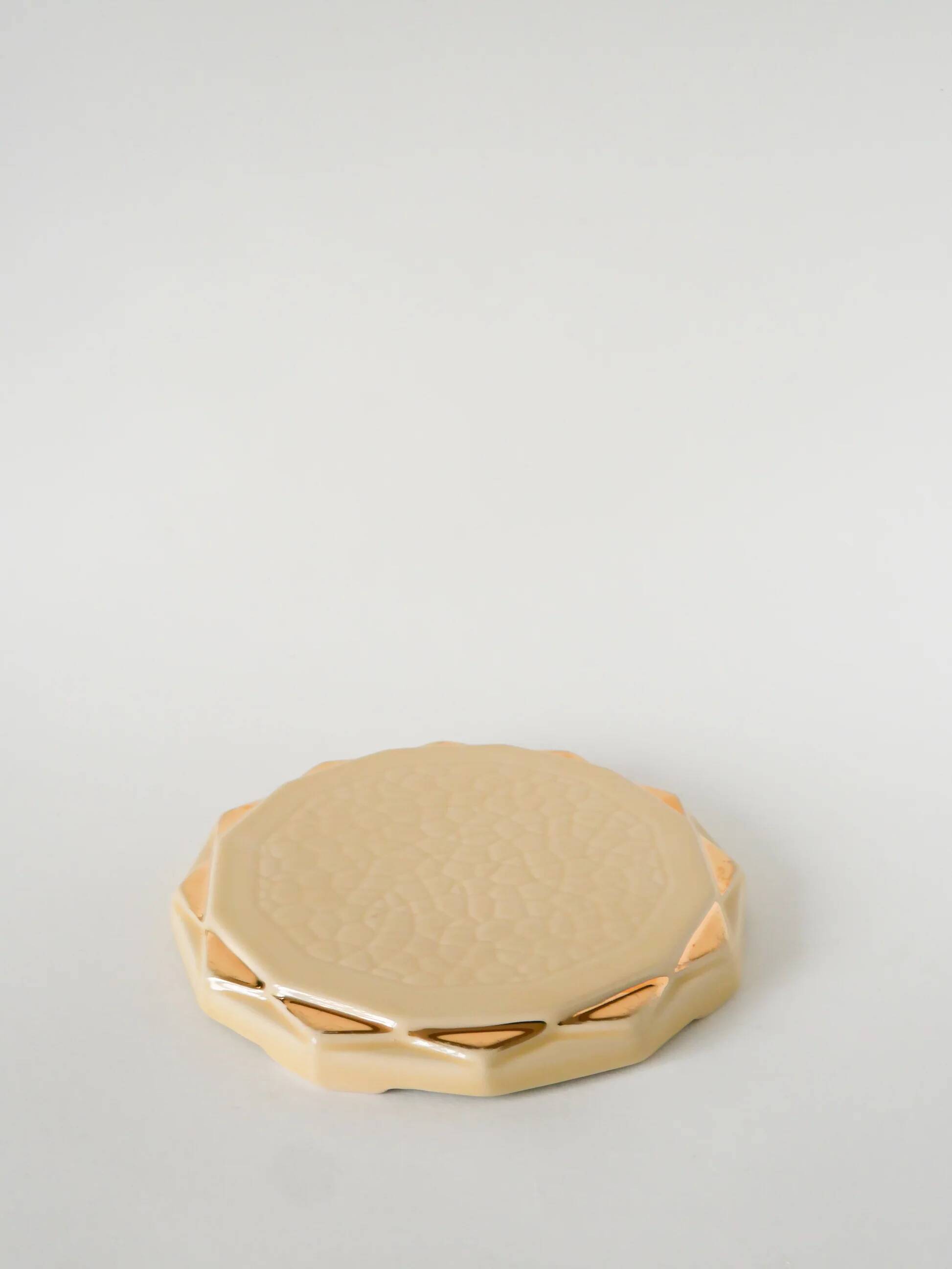 Ceramic trivet, butter yellow and gold, 1960.