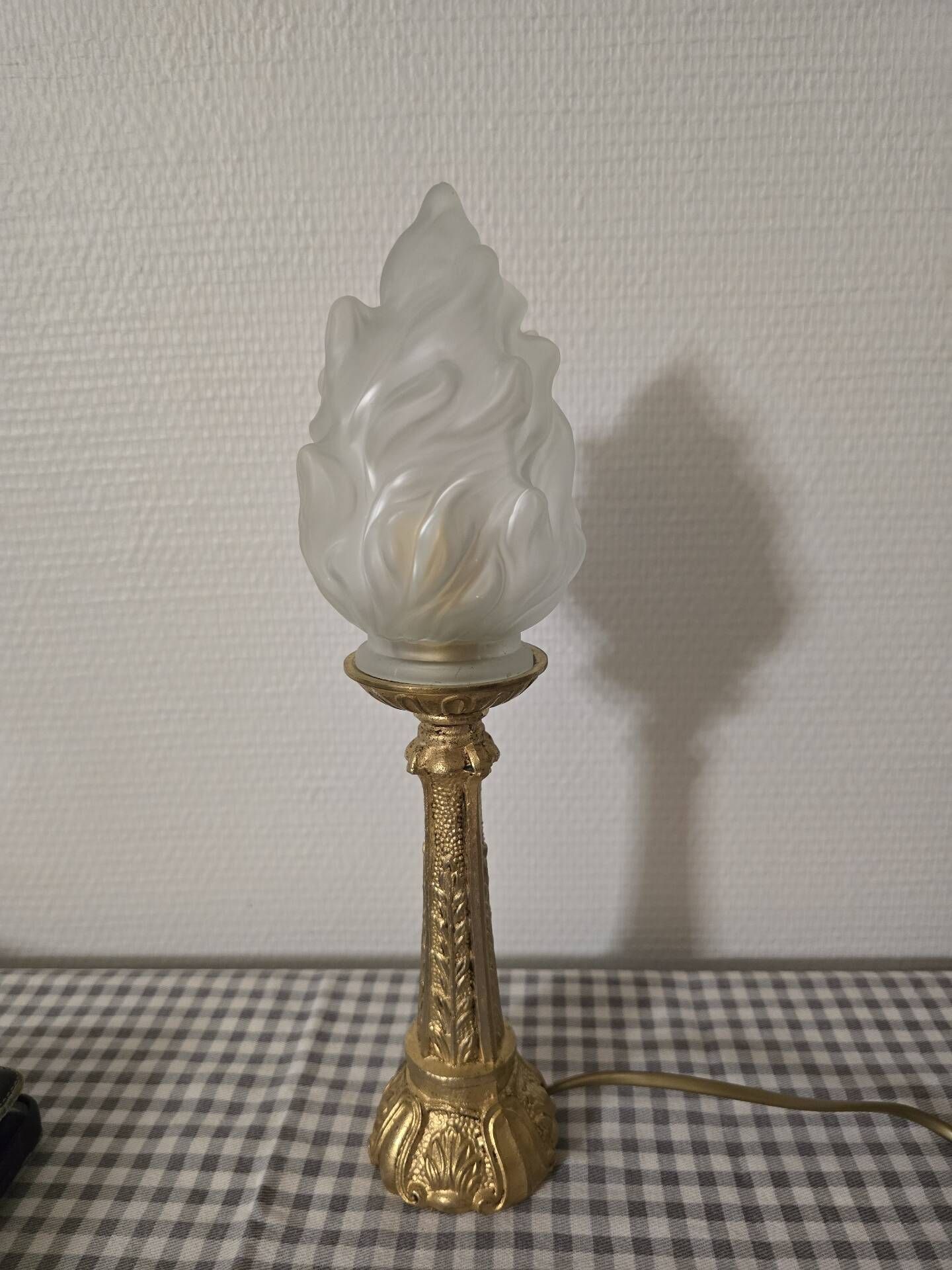 Table lamp with brass base and vintage flame globe