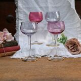 Four colorful stemmed wine glasses