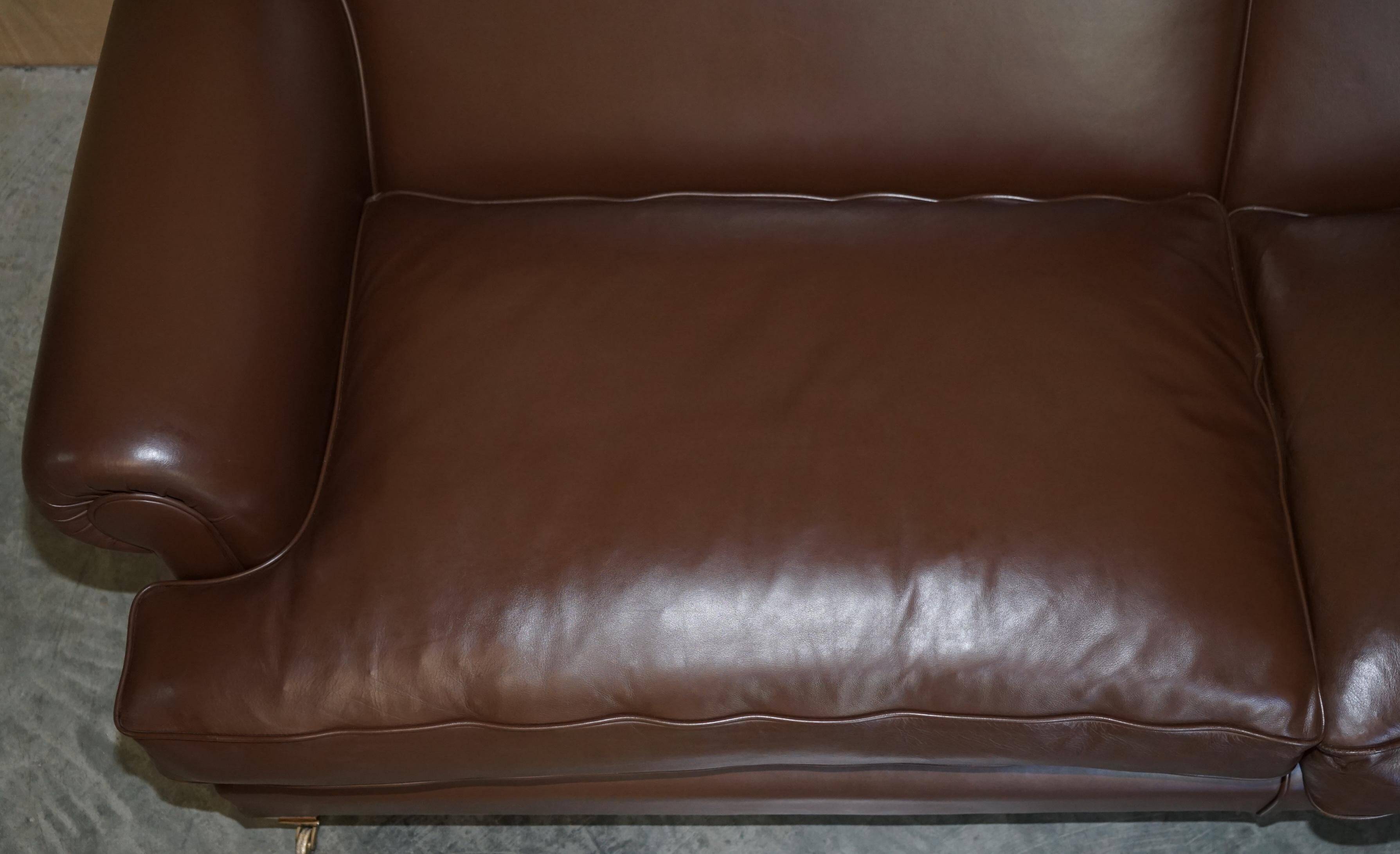 Contemporary Howard & Sons style grand sofa with brass casters.