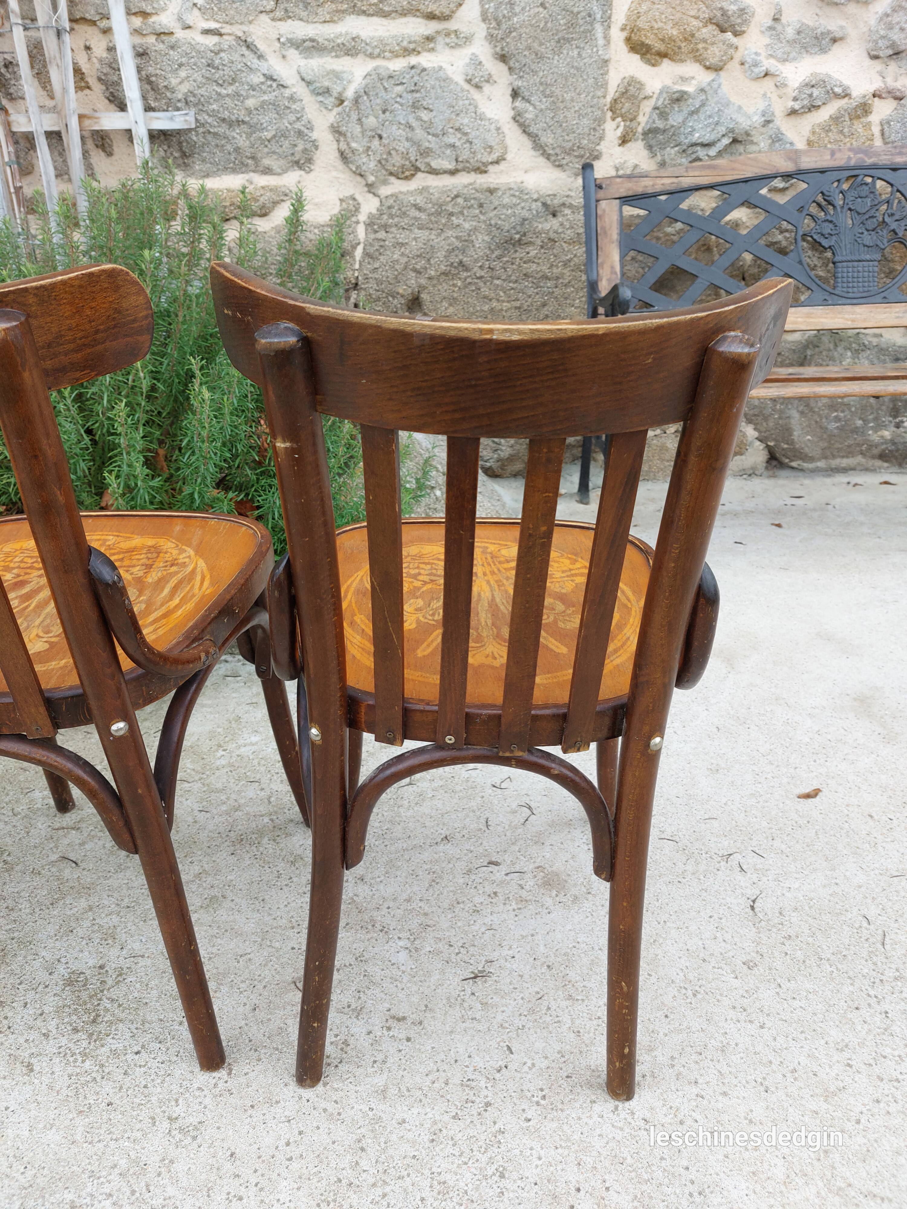 4 bentwood bistro chairs with a pattern on the seat
