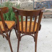 4 bentwood bistro chairs with a pattern on the seat