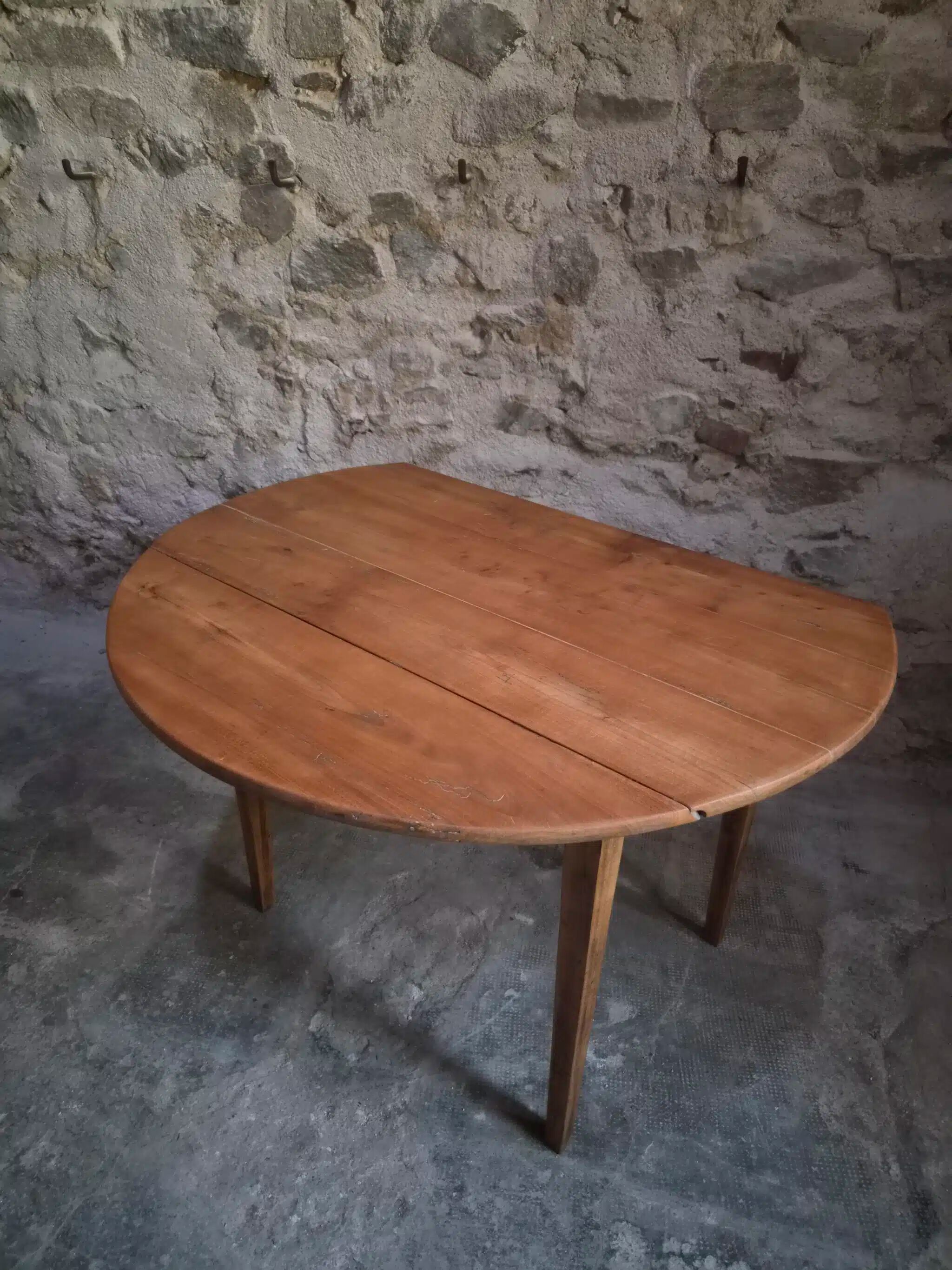 Rustic French antique dining table, drop-leaf table in cherry wood, circa 1900.