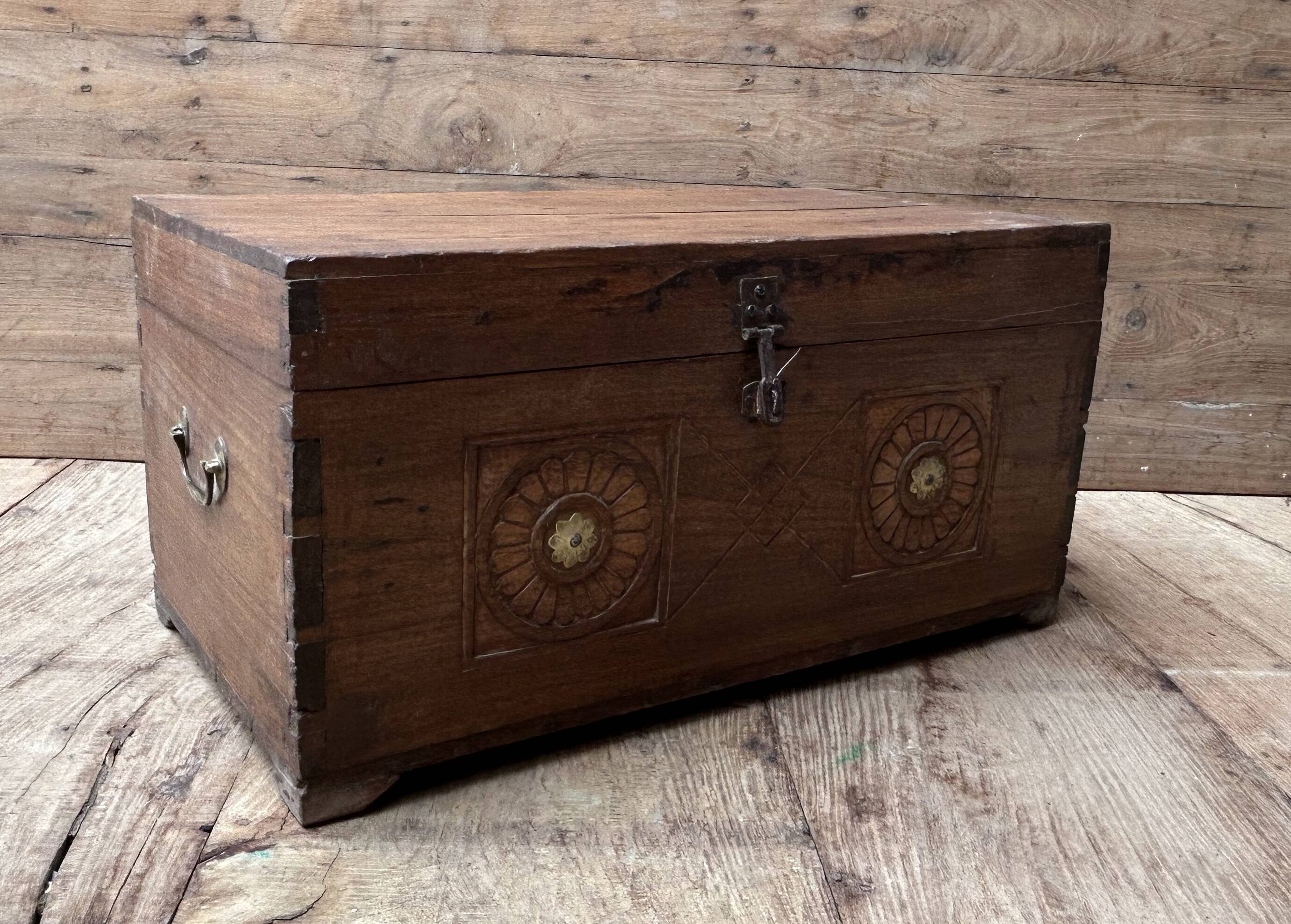 Teak chest from Burma with carved rosettes.