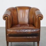 Unique vintage cognac-coloured leather club armchair with black piping