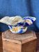 Multi-layer glass ashtray bowl with metallic oxide inclusions.