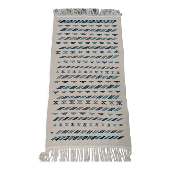 White and blue kilim rug Woven hands Berber patterns