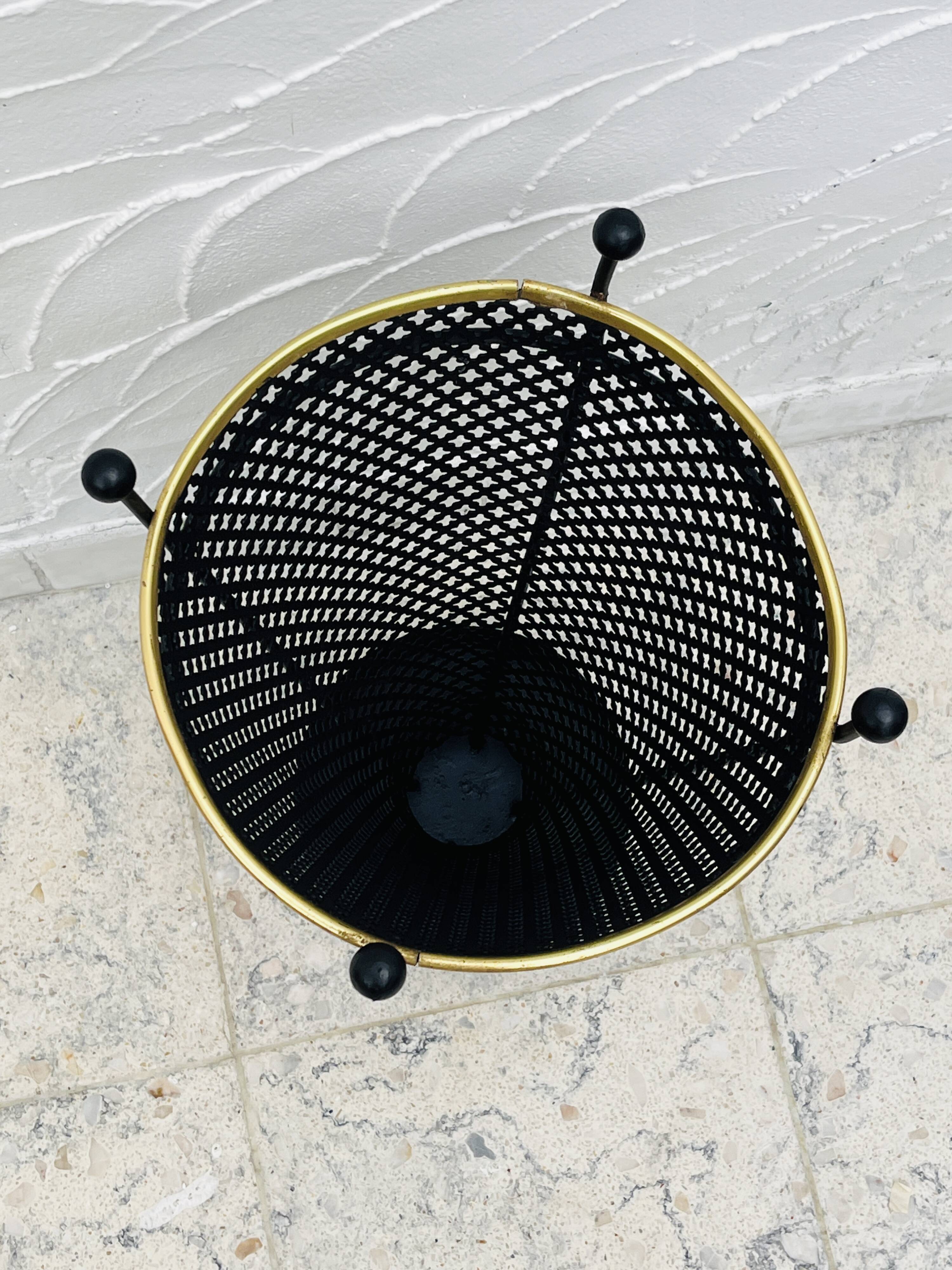 Vintage black perforated metal and brass umbrella stand