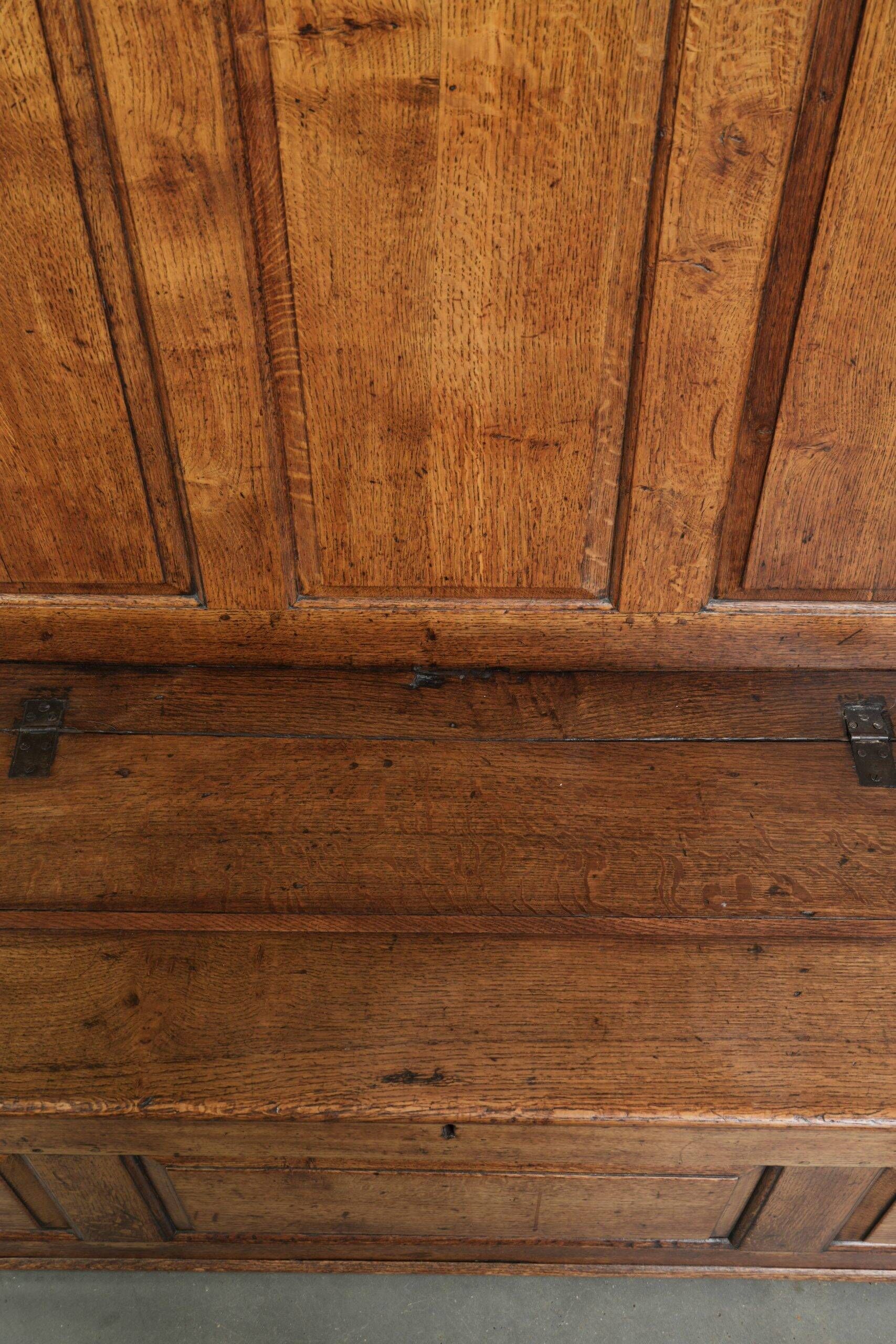 Antique English oak hall bench from the early 19th century with storage space