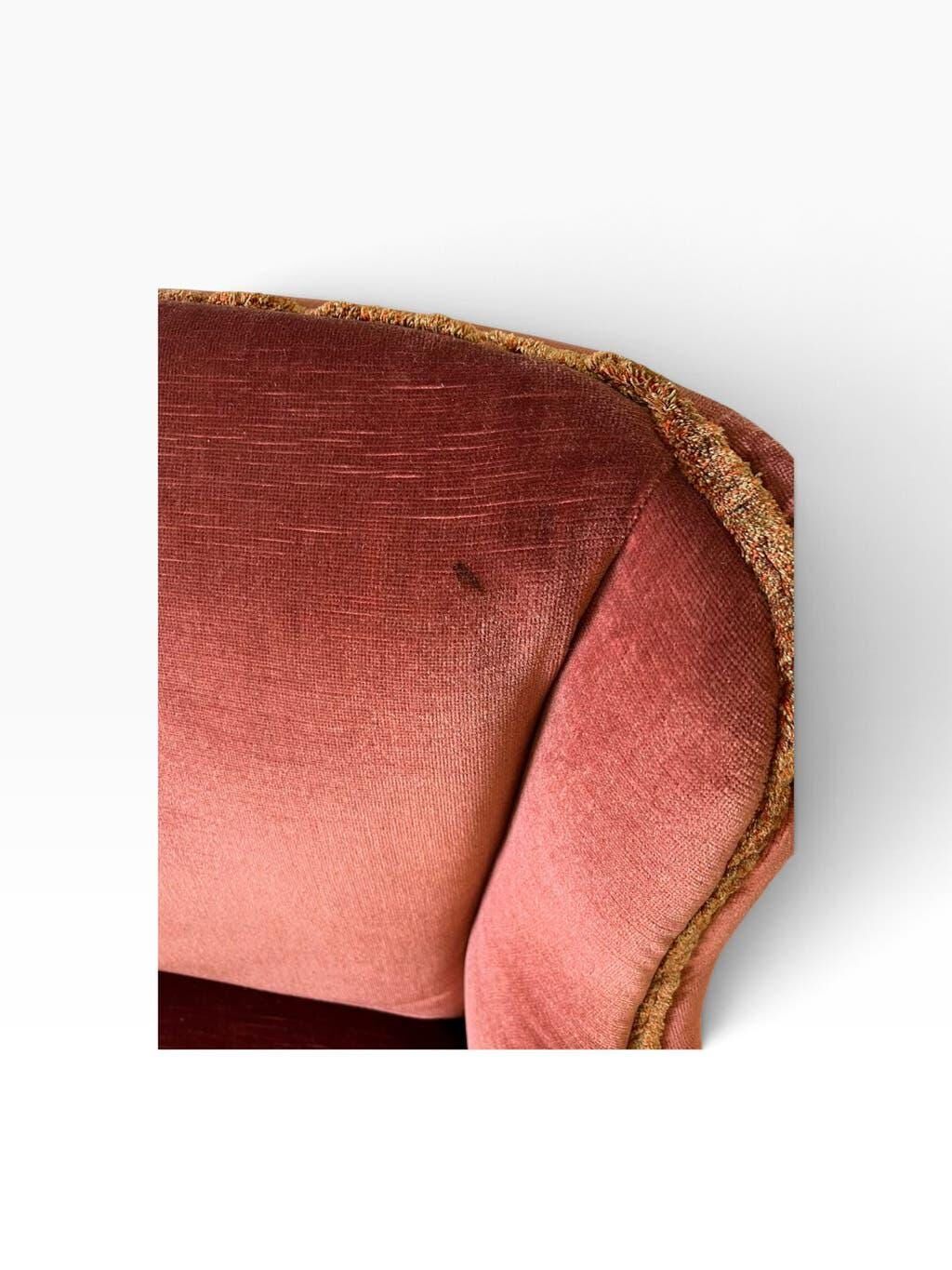 Vintage two-seater armchair in powder pink velvet with fringes.