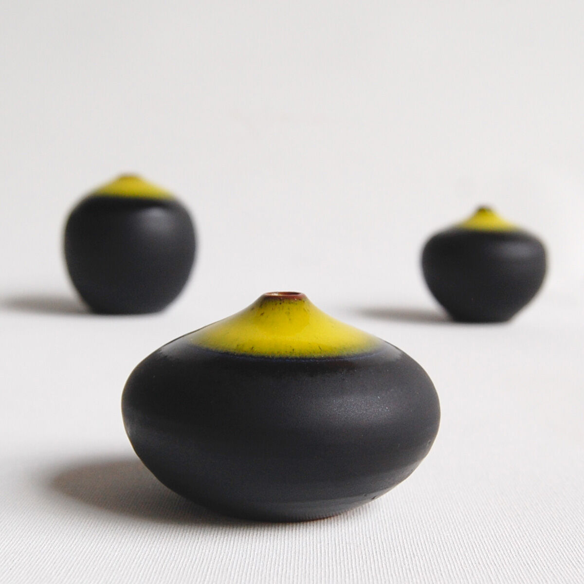 Trio of black and yellow miniature ceramics Antonio Lampecco