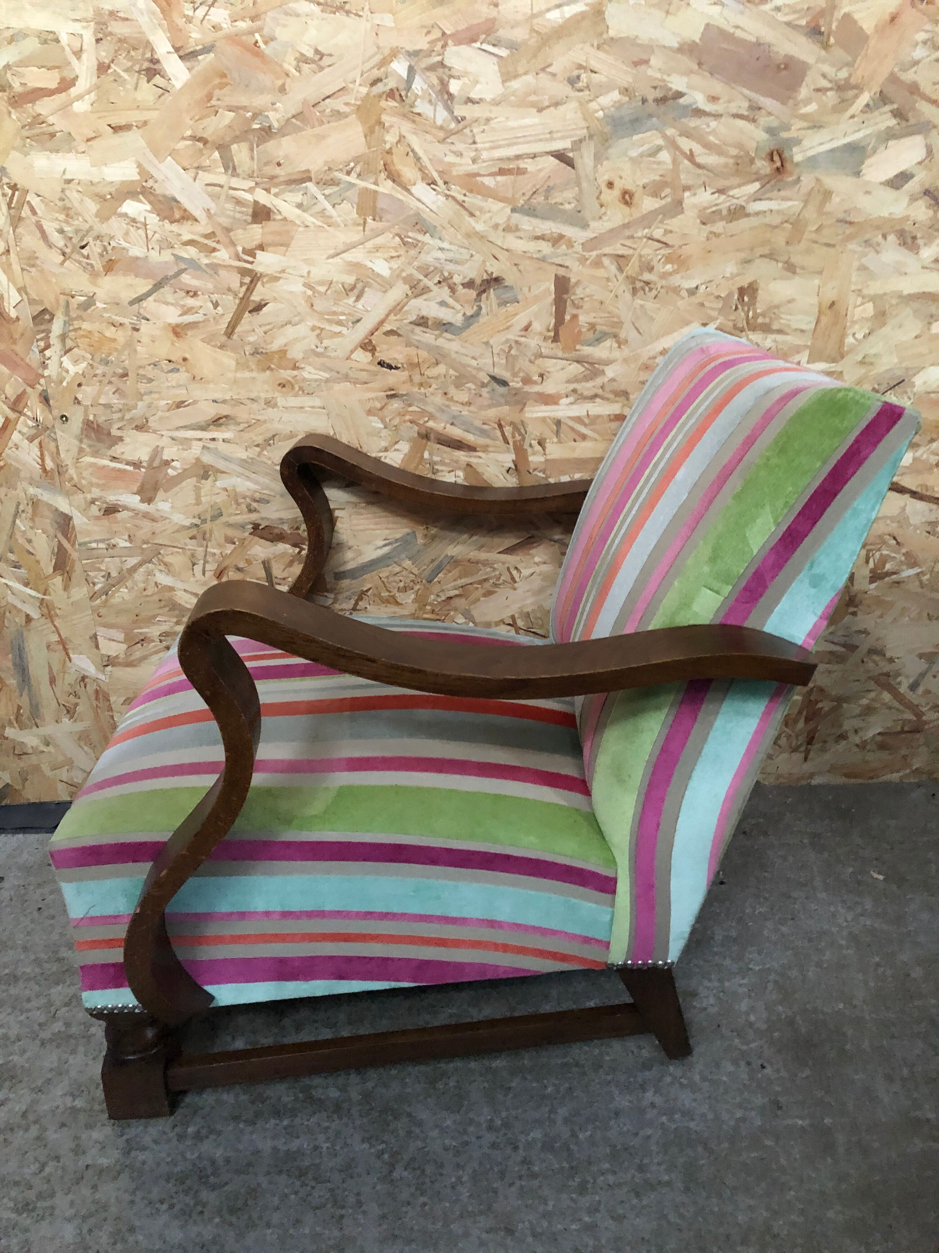 Old wooden armchair with curved armrests