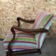 Old wooden armchair with curved armrests