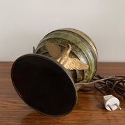 Art Deco table lamp in patinated bronze with eagles holding a globe, France 1940.
