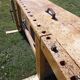 Old solid wood carpenter's bench with 2 functional vices.