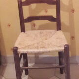 2 wooden and straw chairs