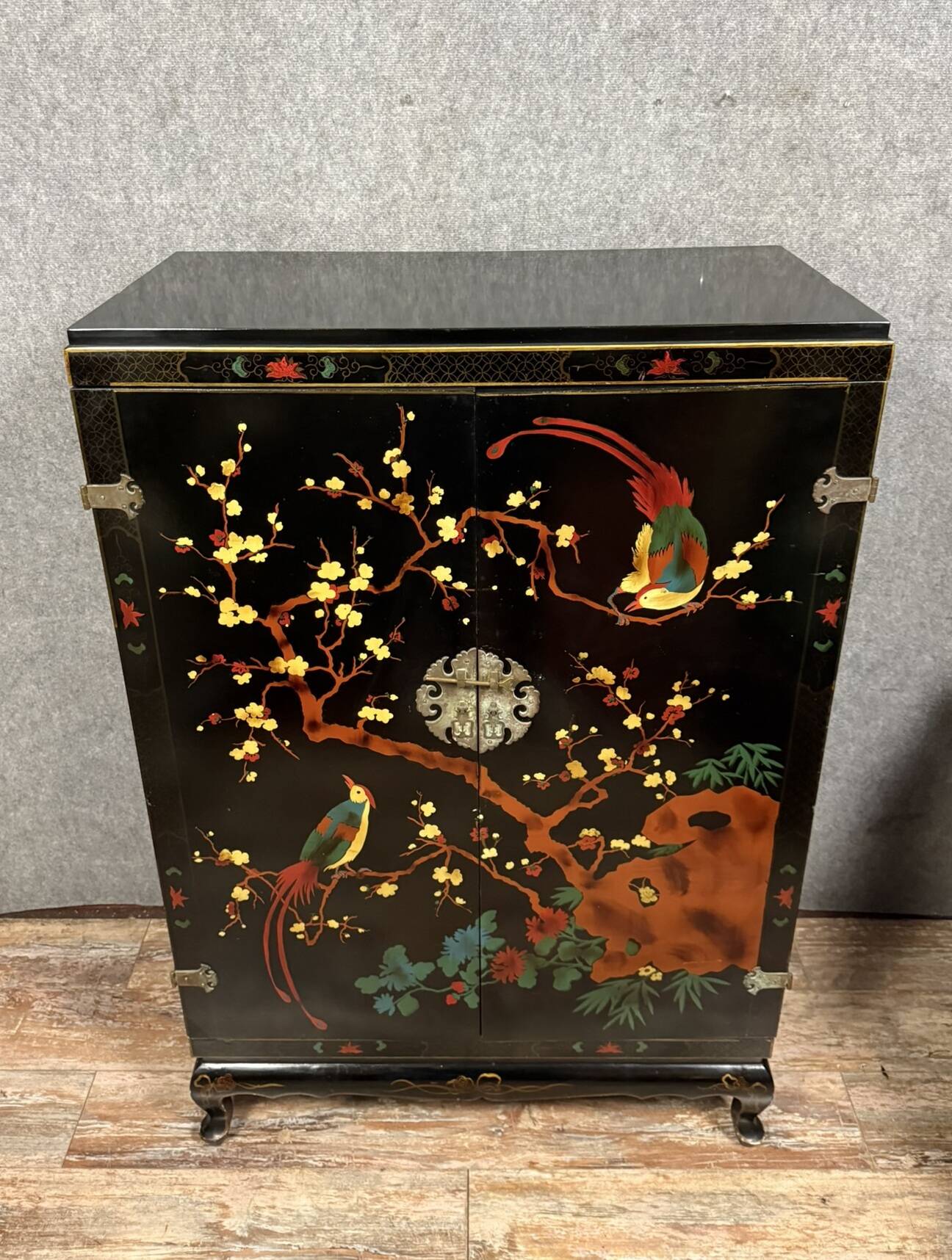 Chinese cabinet in black lacquer and colored decorations