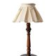 Table lamp with a carved wooden base and pleated lampshade