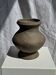 Small brutalist handcrafted terracotta vase with a pedestal, Indonesian, H19 D17.