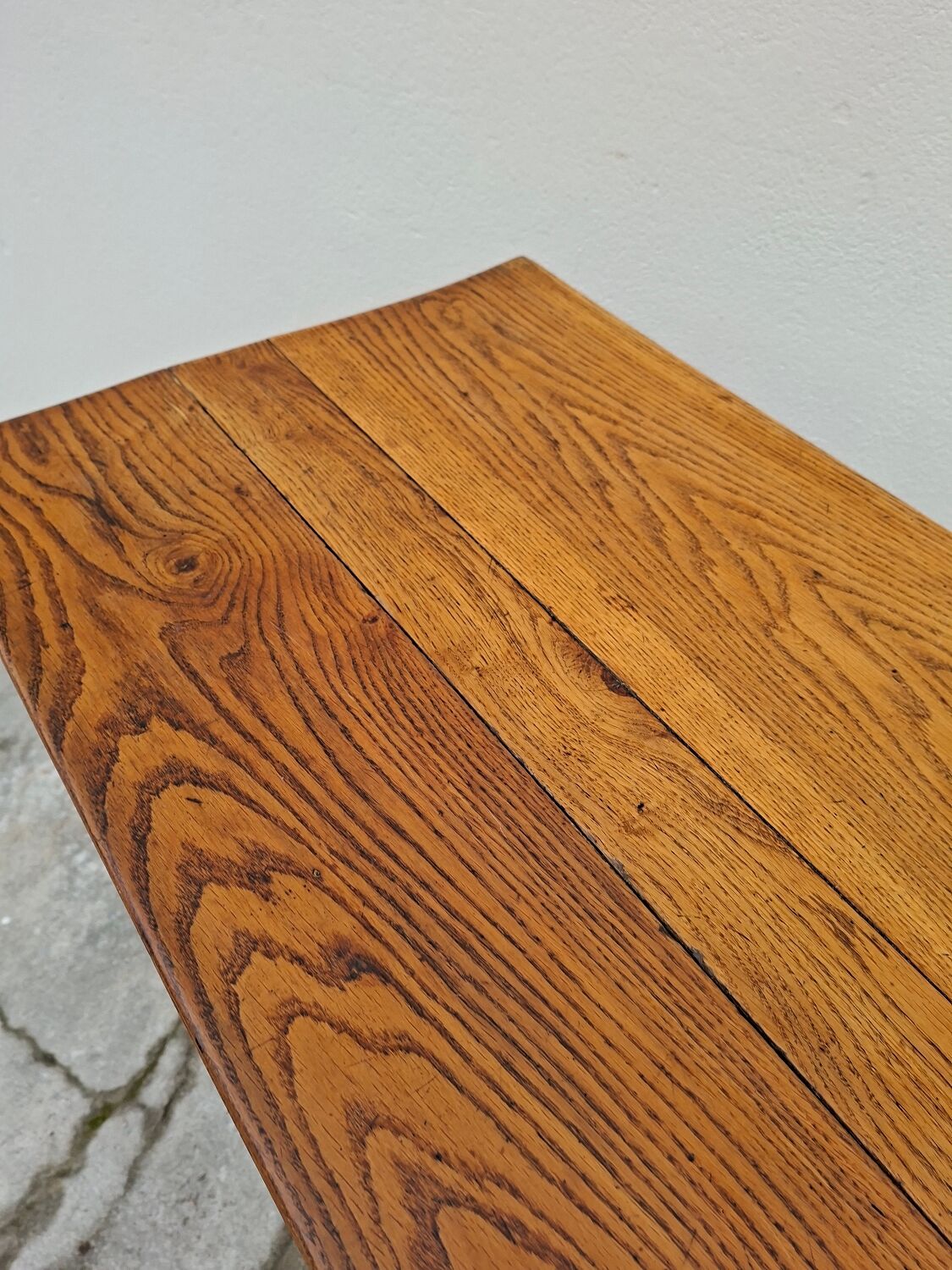 Solid oak bistro table with a cast iron base, signed.