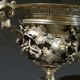 Carved silver bronze vase mounted on marble pedestal