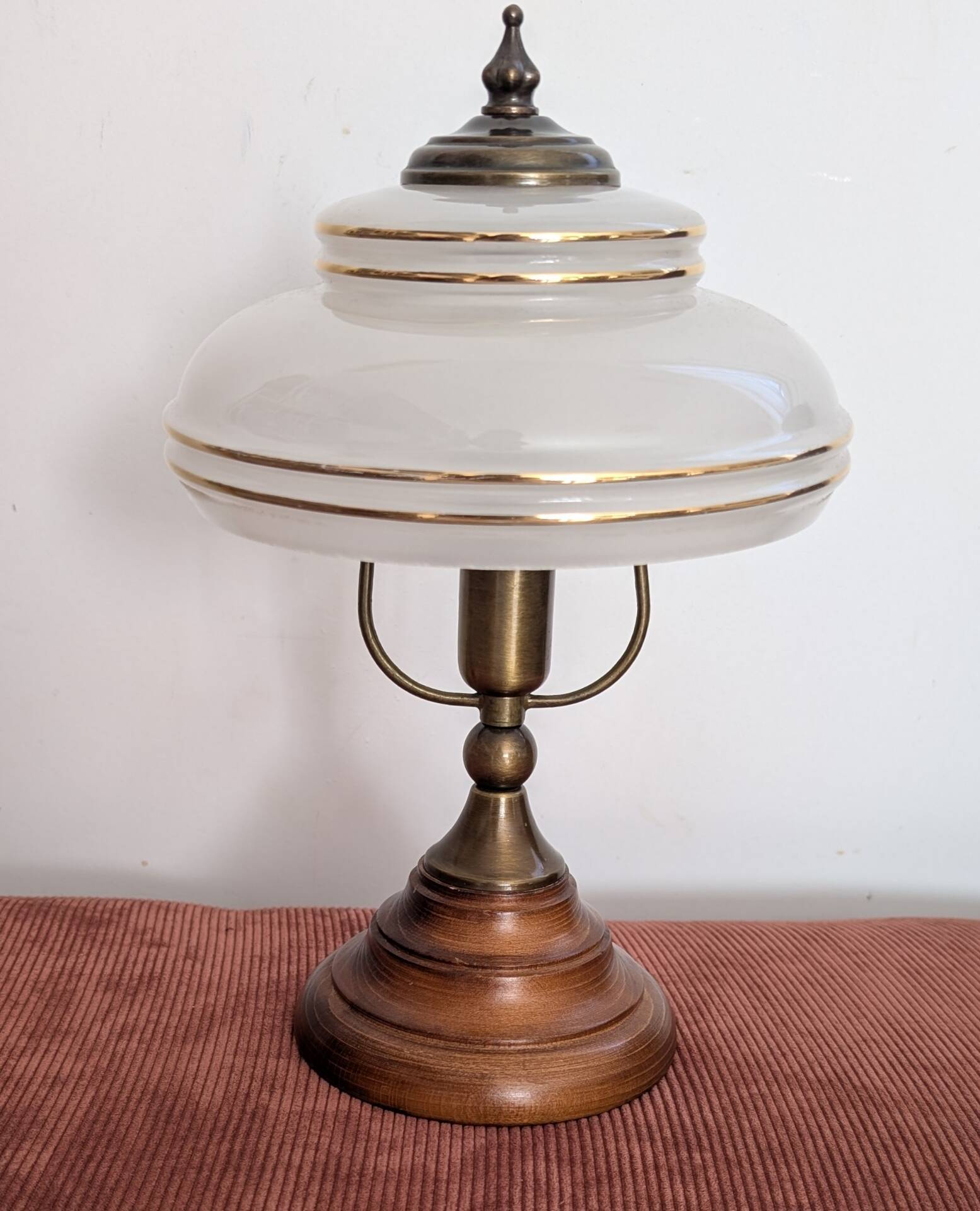 Vintage lamp made of turned wood, brass, and frosted glass.
