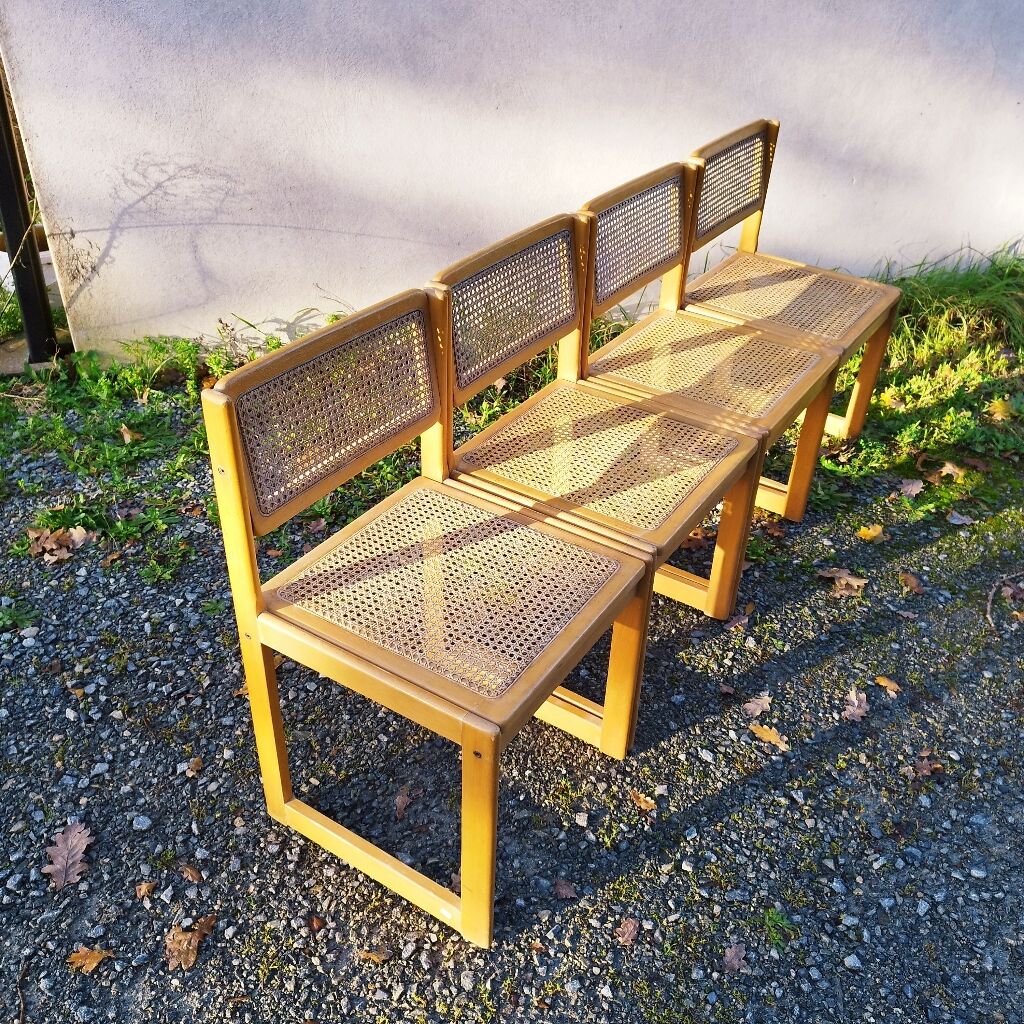 Four trendy tanned wooden chairs