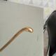 Old coat hook in solid golden brass