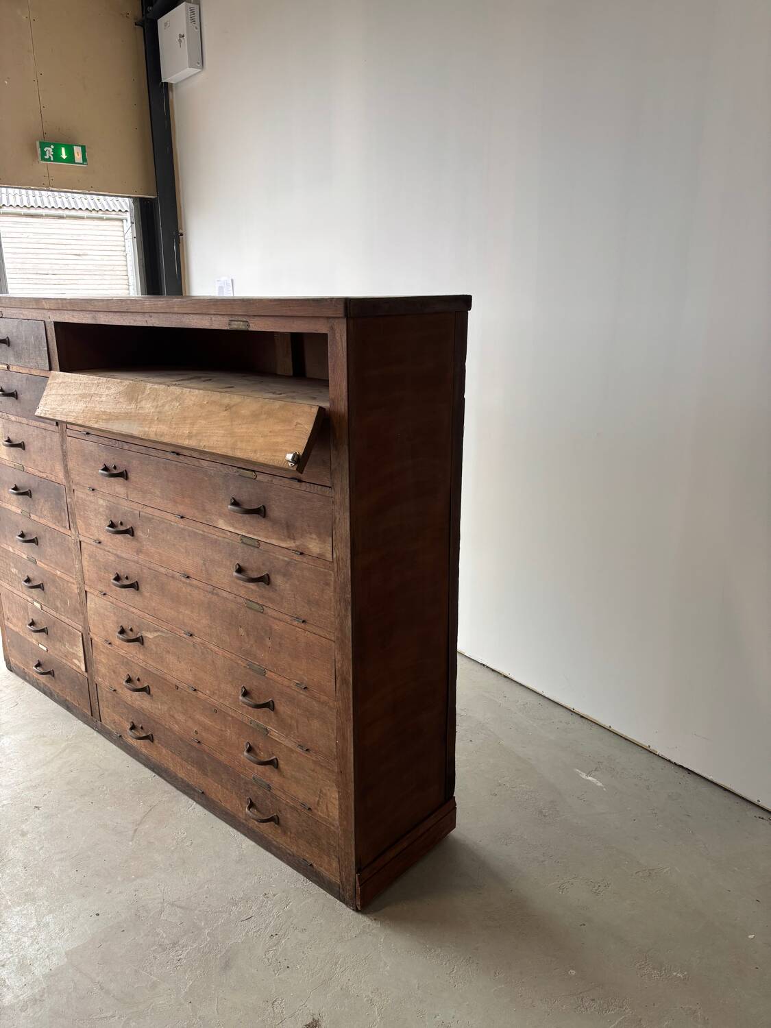 Large wooden workshop cabinet with 16 drawers, antique from the early 1900s.