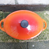 Old oval casserole in orange enamelled cast iron
