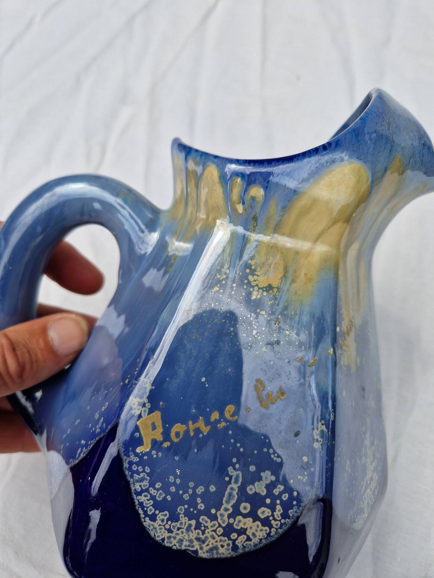 Old flamed ceramic jug. Very beautiful shades of blue, 6 sides.
