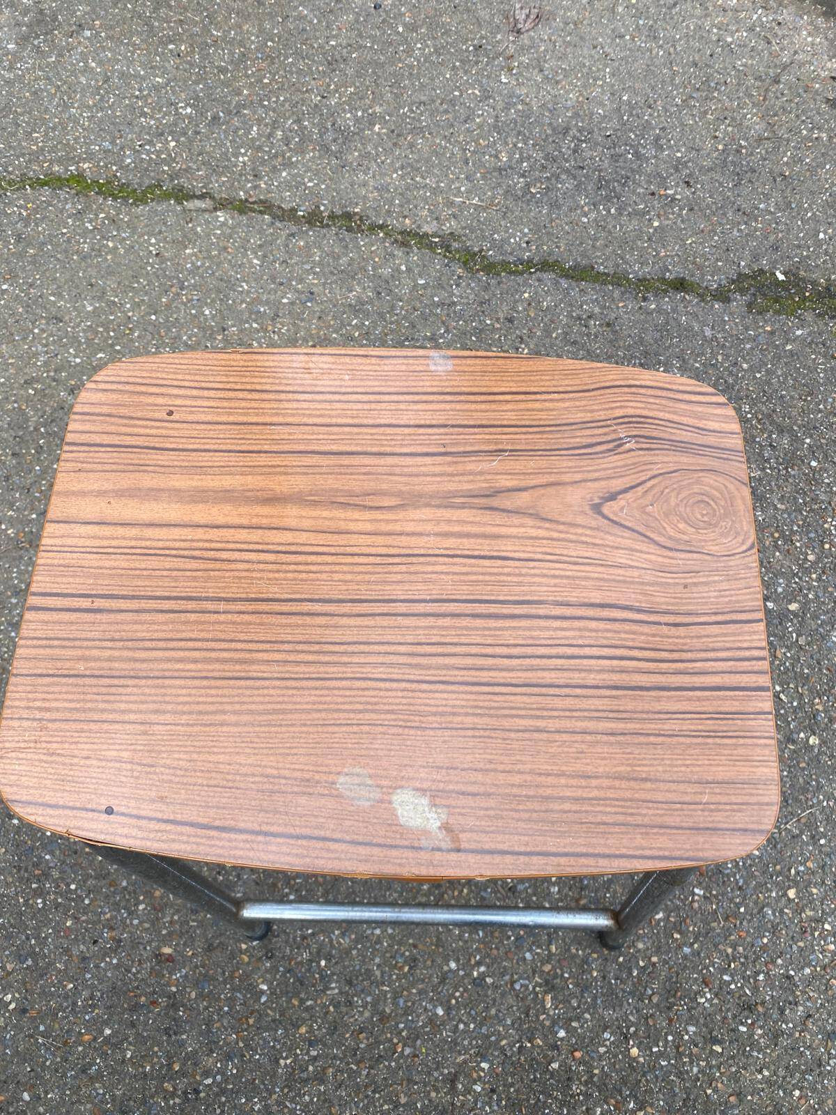 Folding stool in formica with a wood effect.