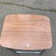 Folding stool in formica with a wood effect.