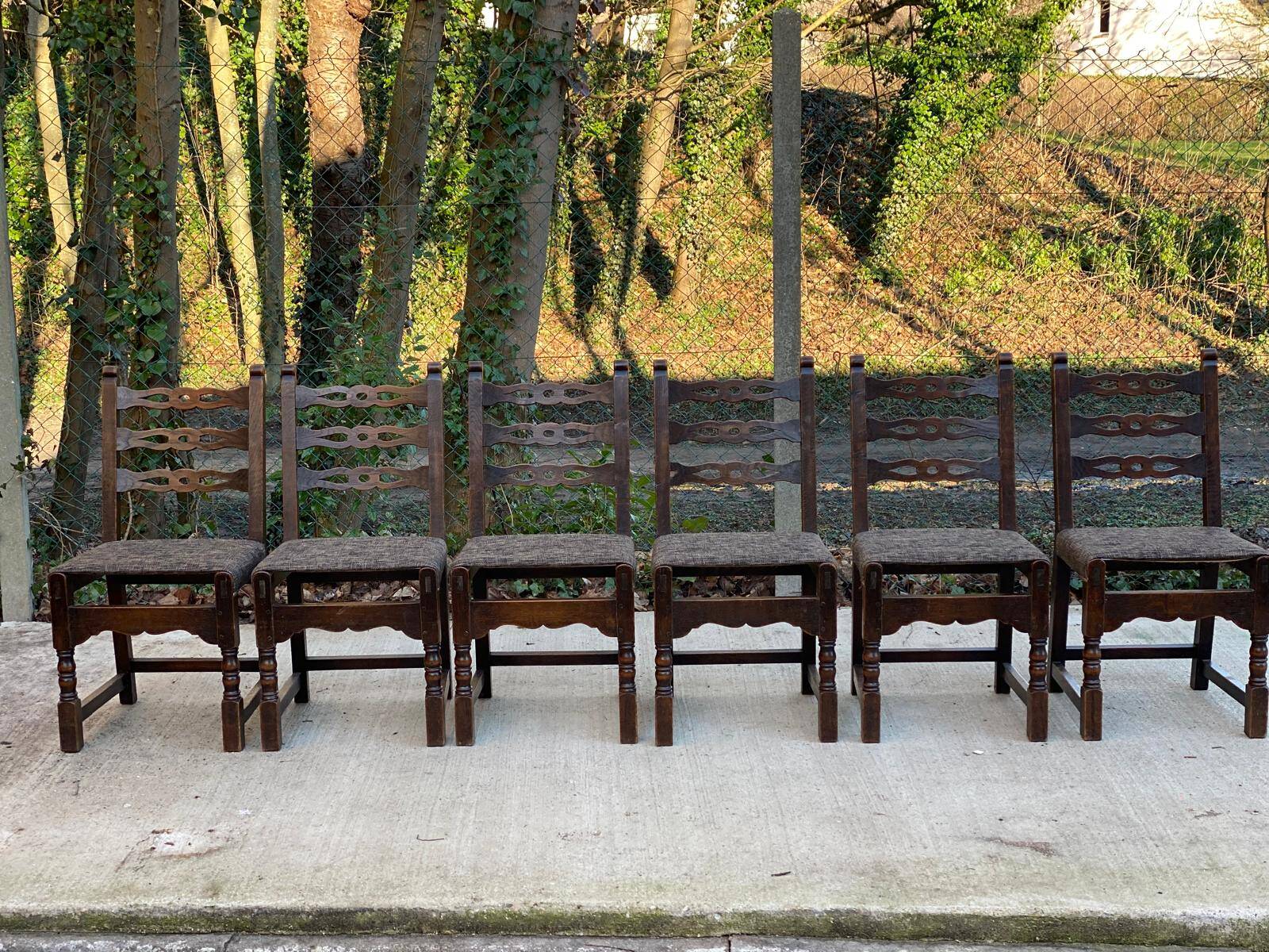 6 solid wood dining chairs with grey woven wool seats.