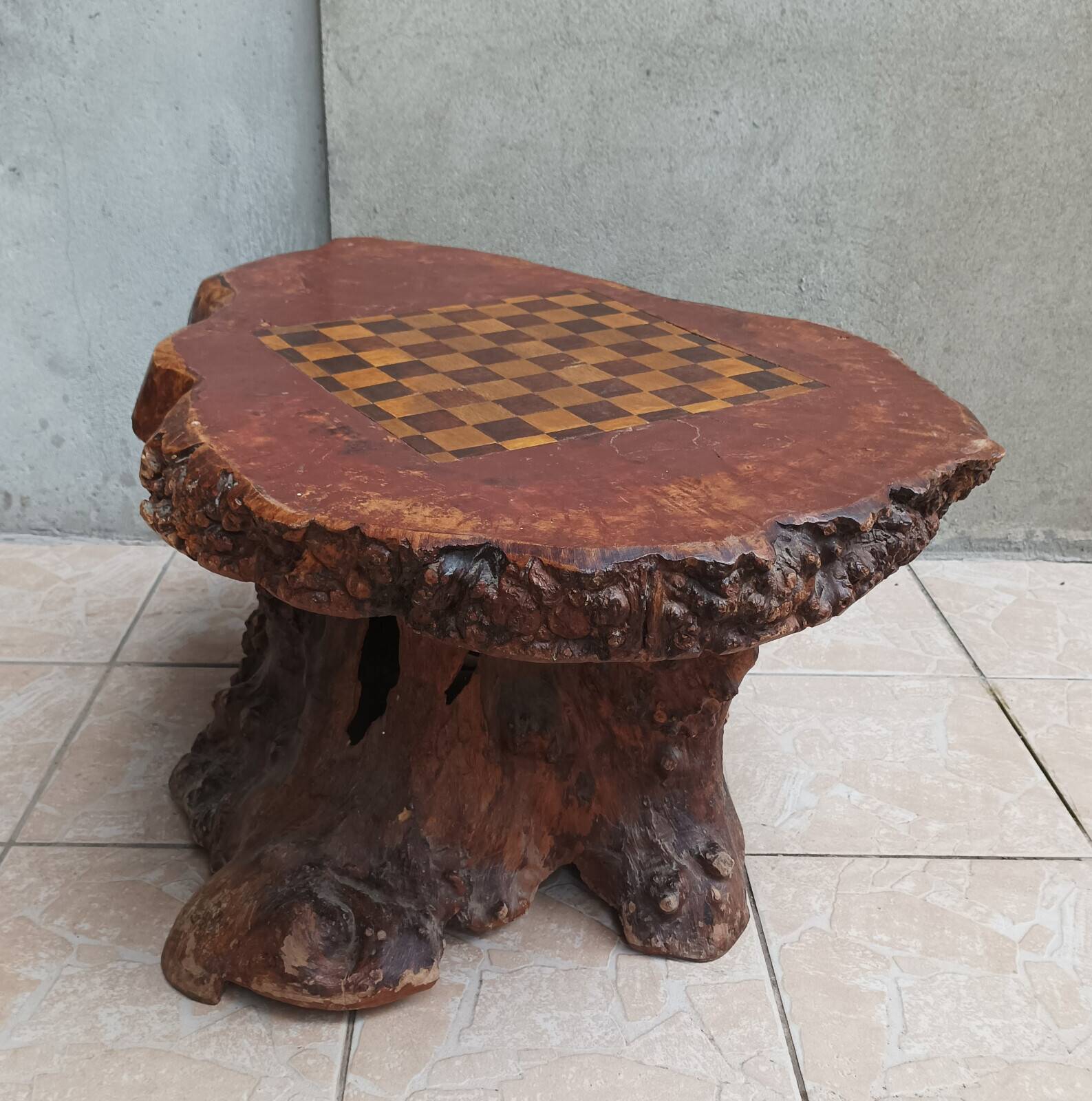 Brutalist chessboard coffee table made from tree stump.