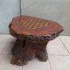 Brutalist chessboard coffee table made from tree stump.