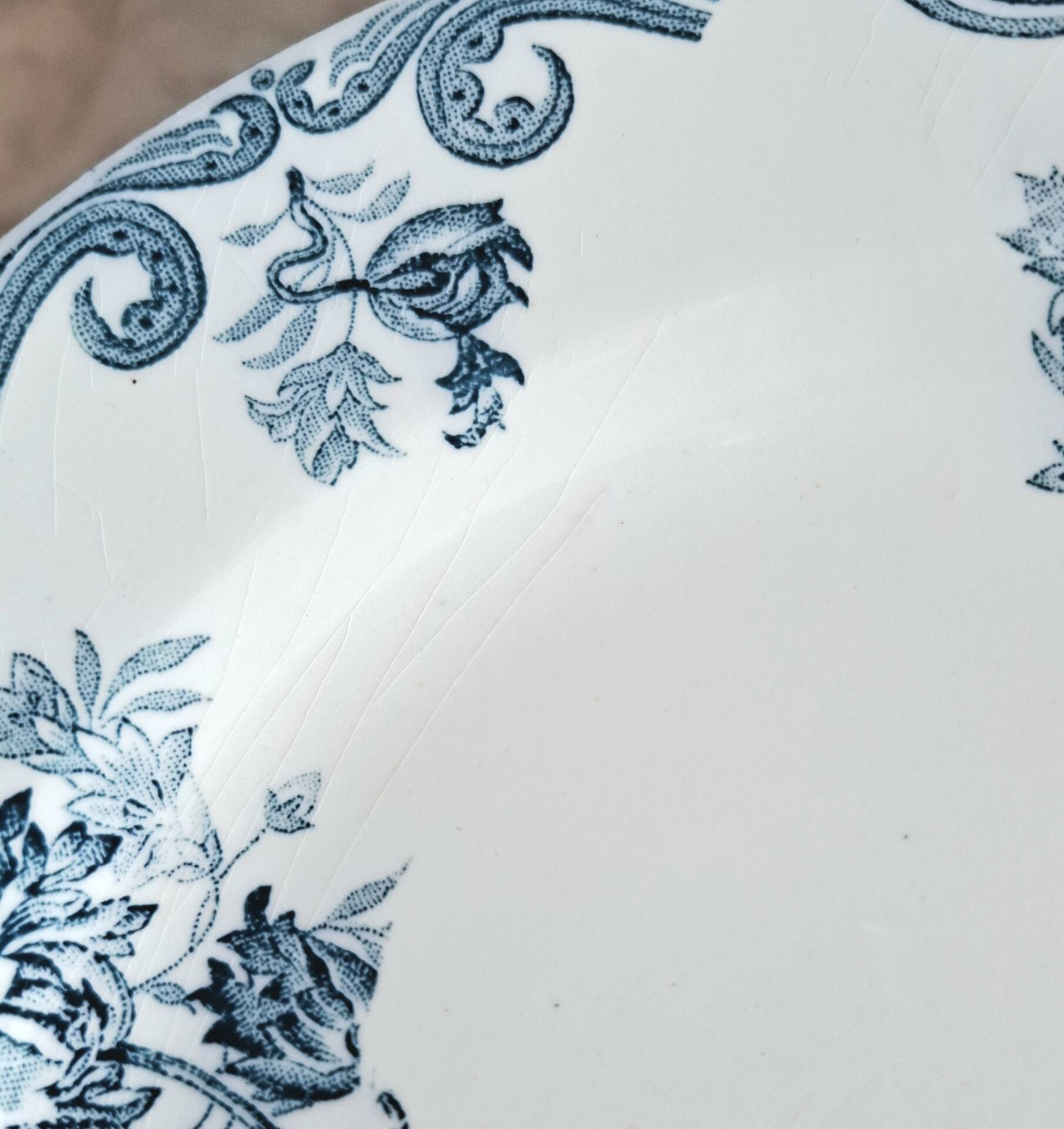 Old mismatched flat plates made of ironstone earthenware.